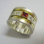 Red Sapphire and Scattered Diamonds In A Gold Spinning Ring